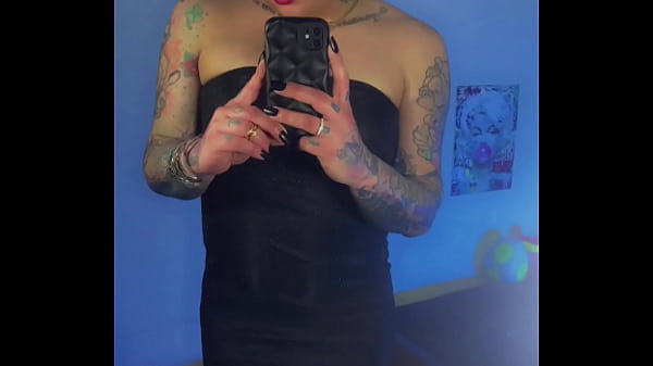 Trans girl Emma Ink shows off in the mirror in high heels and a short dress. Without panties his big dick was loose